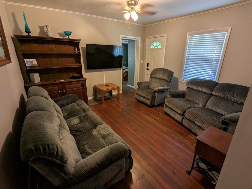 a living room with couches and a flat screen tv at MinCo Properties WV, Carswell Hollow Overlook in Kimball