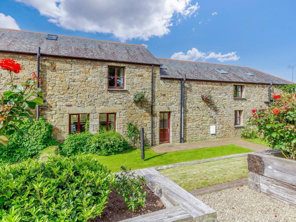 an old stone house with a garden in front of it at 3 Bed in Praa Sands 36257 in Germoe