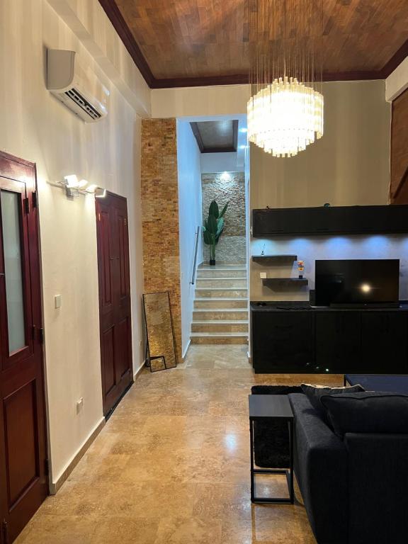 a living room with a couch and a chandelier at Casa Luna Royale in San Juan