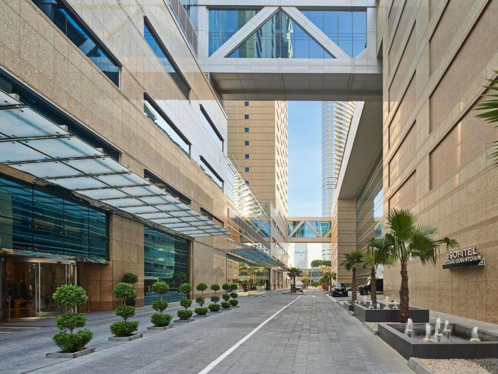 a building with a walkway in the middle of a street at Sofitel Dubai Downtown in Dubai