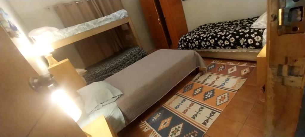 a bedroom with a bed and a table with a light at Patagonia Mágica in Punta Arenas