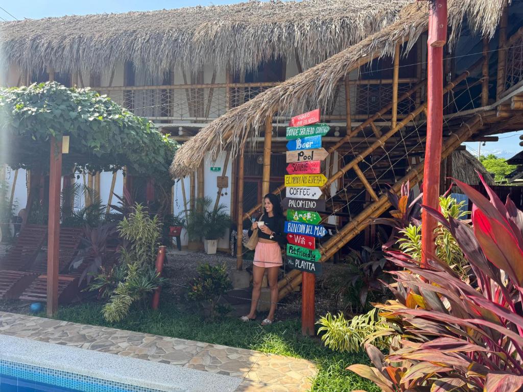 a woman standing next to a sign in front of a building at Rincon del Mar Palomino in Palomino