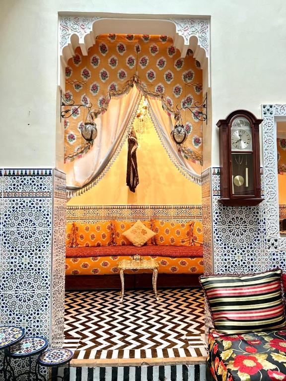 a living room with a curtain and a couch at Hadi house in Fès