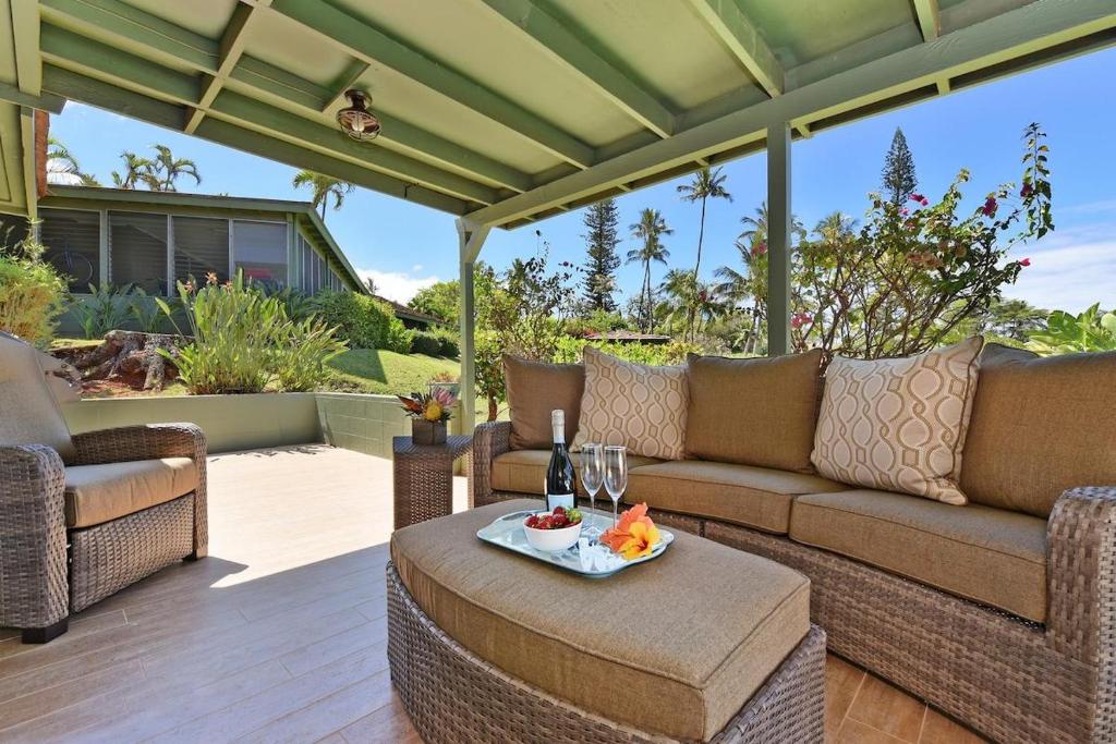 a patio with a couch and chairs and a table at International Colony Club 20 · ICC 20 Remodeled 2BD Hawaiian Co in Lahaina