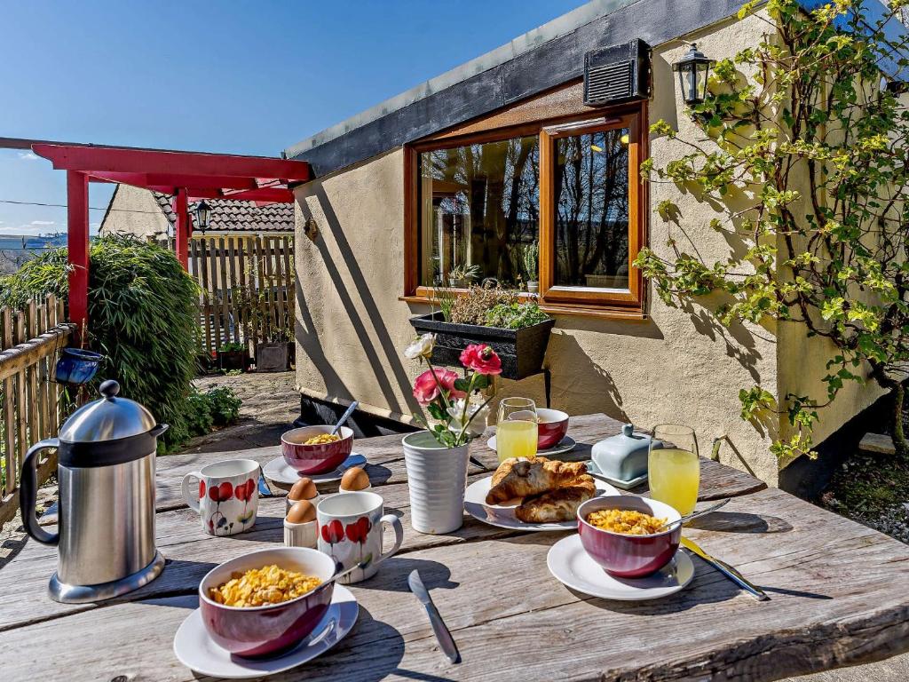 a wooden table with food and drinks on it at 2 Bed in Tregaron 43293 in Tregaron