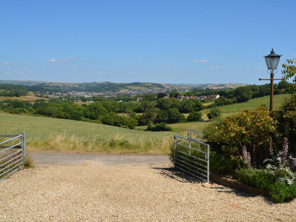 a gate to a hill with a view of a field at 2 Bed in Bridport 88614 in Chideock