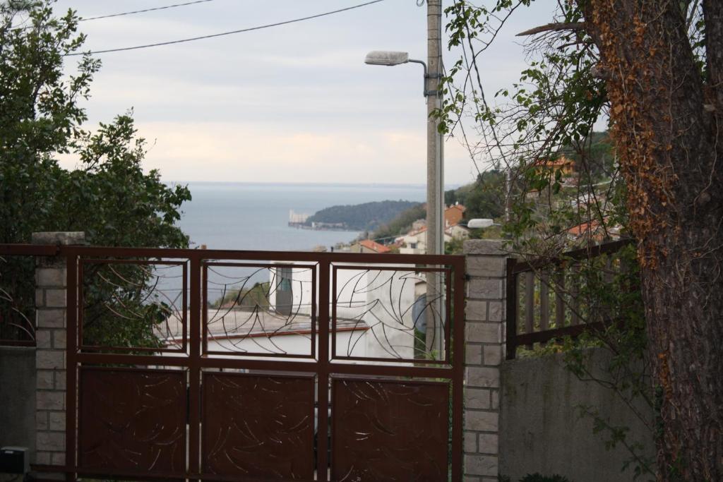 a wooden gate with a view of the ocean at B&B Villa Inn in Trieste