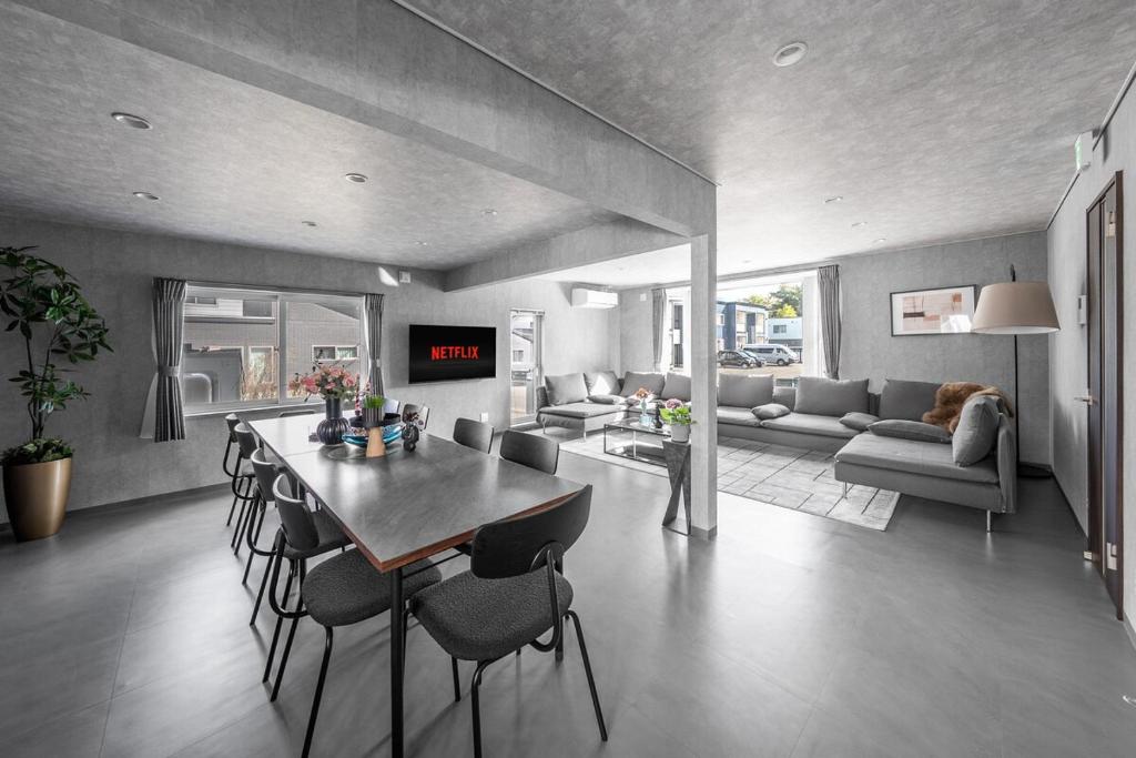a kitchen and living room with a table and chairs at The Arklune in Sapporo