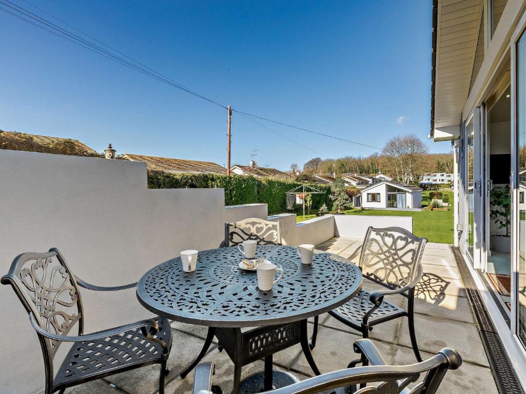 a patio with a table and chairs on a balcony at 2 Bed in Brixham 90912 in Brixham