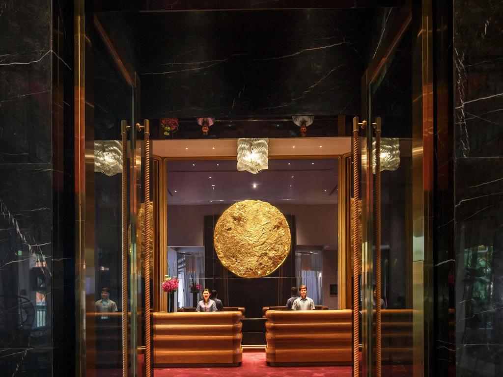 una habitación con dos personas sentadas en un banco en Sofitel Singapore Sentosa, en Singapur