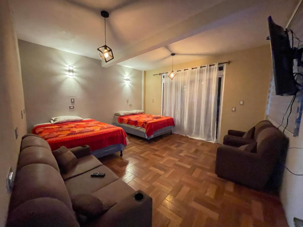 a living room with two beds and a couch at Casa Lolita in San Juan La Laguna