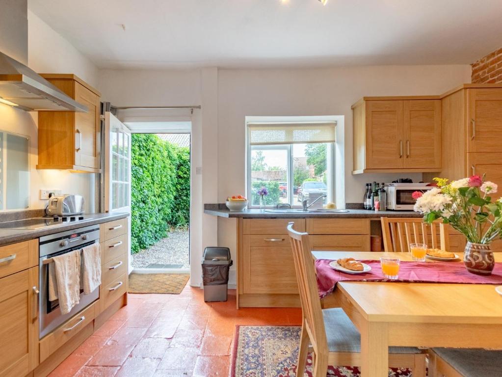 a kitchen with a table and a dining room at 2 Bed in Blakeney NCC66 in Blakeney