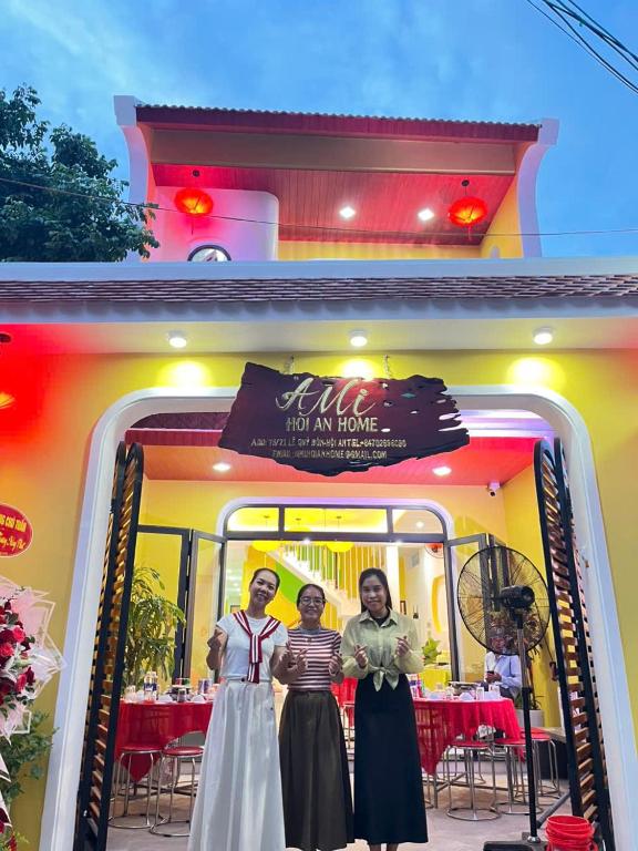 two women standing in front of a restaurant at Ami Hoi An Home in Hoi An