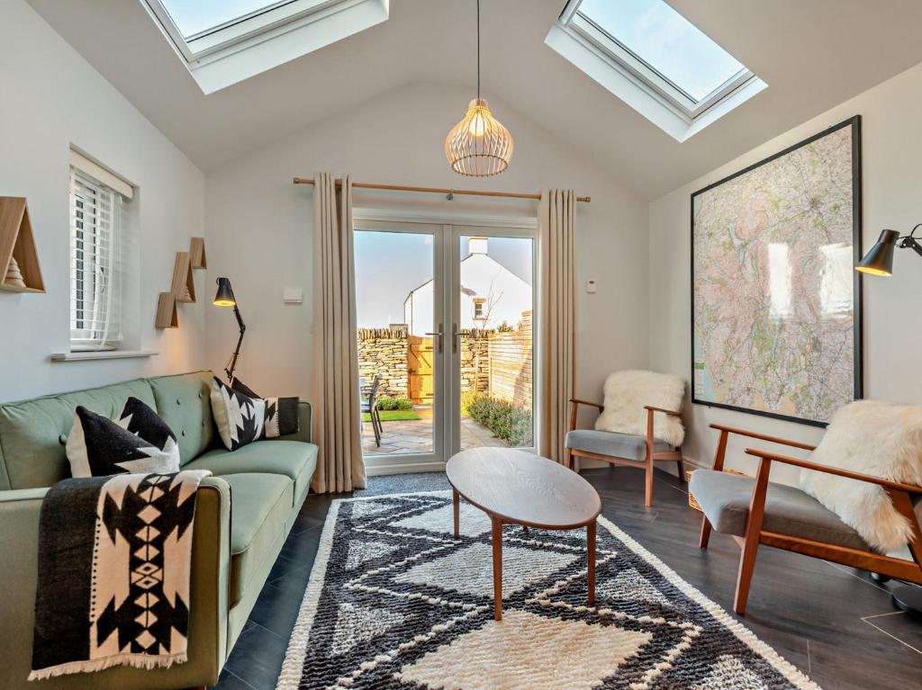a living room with a green couch and a table at 3 Bed in Loweswater 94152 in Arlecdon