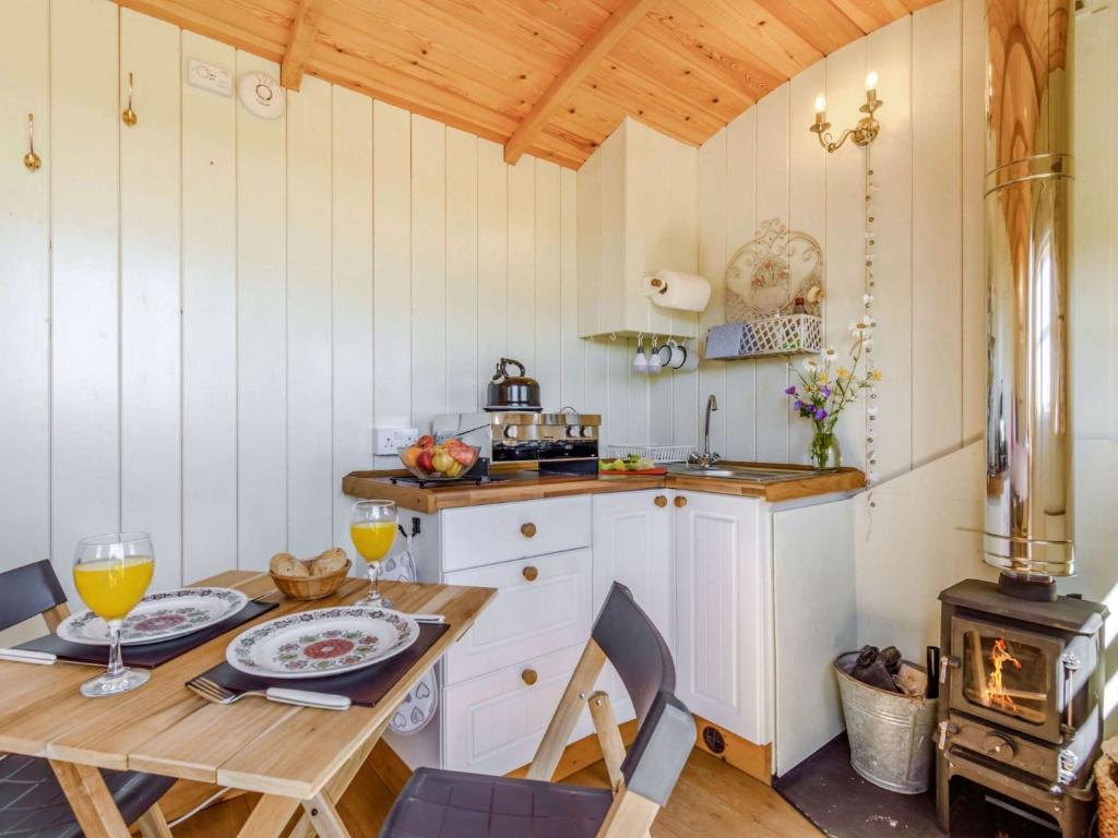 a kitchen with a table and a stove at 1 Bed in Horam 88900 in Horam