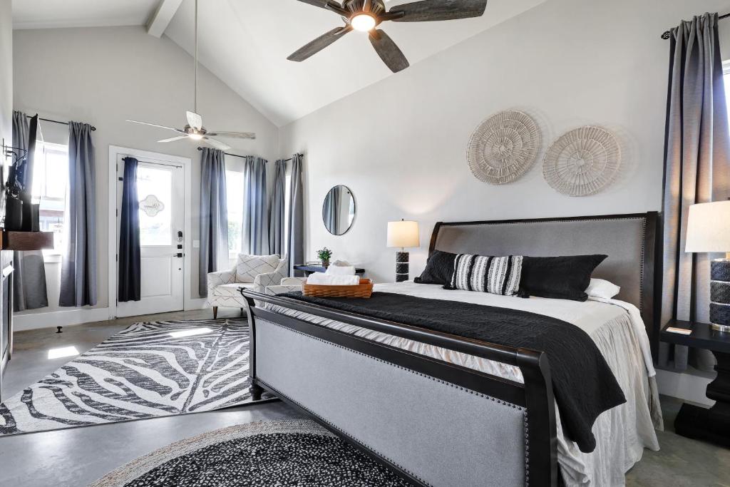 a bedroom with a bed and a ceiling fan at Blanco - A Birdy Vacation Rental in Fredericksburg