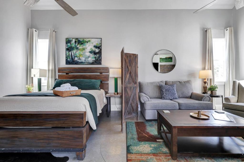 a bedroom with a bed and a living room with a couch at Llano - A Birdy Vacation Rental in Fredericksburg