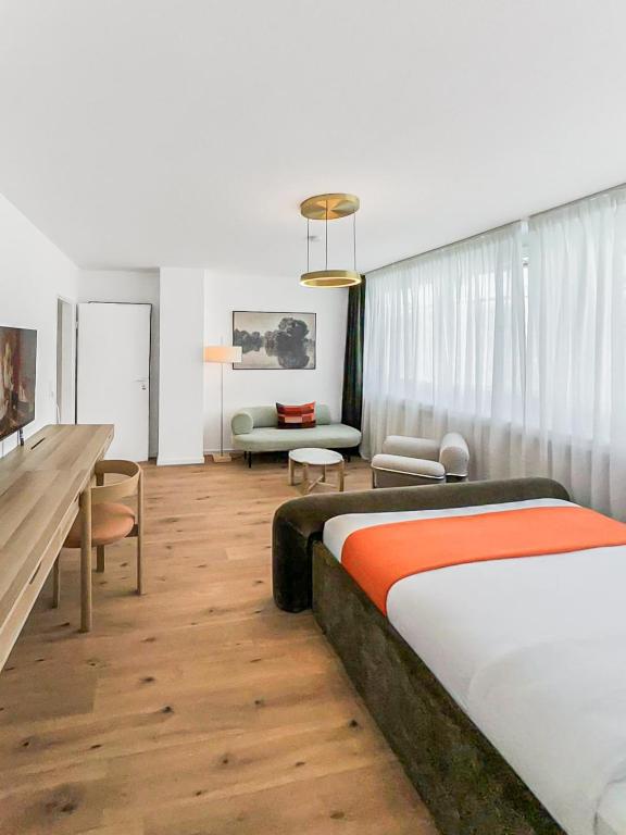 a bedroom with a bed and a living room at Chic City Apartment, 1BR for 2, Elegant Comfort, City Center in Wuppertal