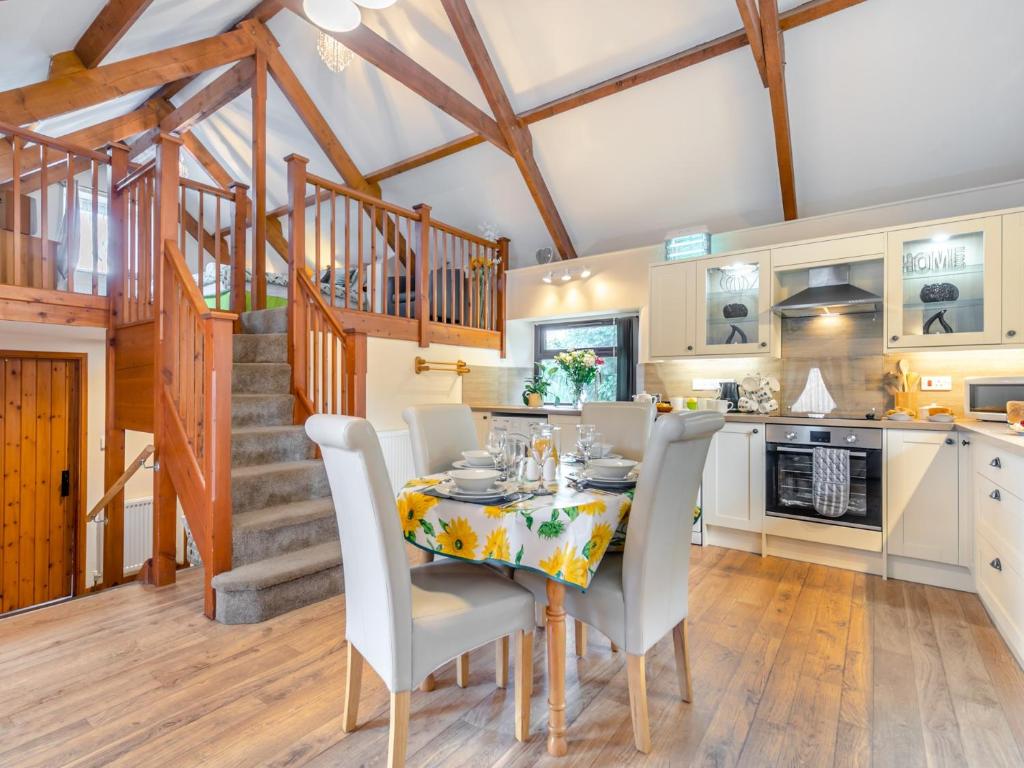 a kitchen and dining room with a table and chairs at 2 Bed in Launceston TILLI in Virginstow