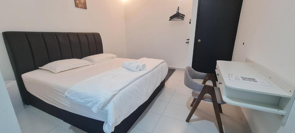 a bedroom with a bed with a sink and a desk at RuzZana Signature Stay Semi-D Corner Lot-BBQ,Wifi,6-8pack in Kota Tinggi