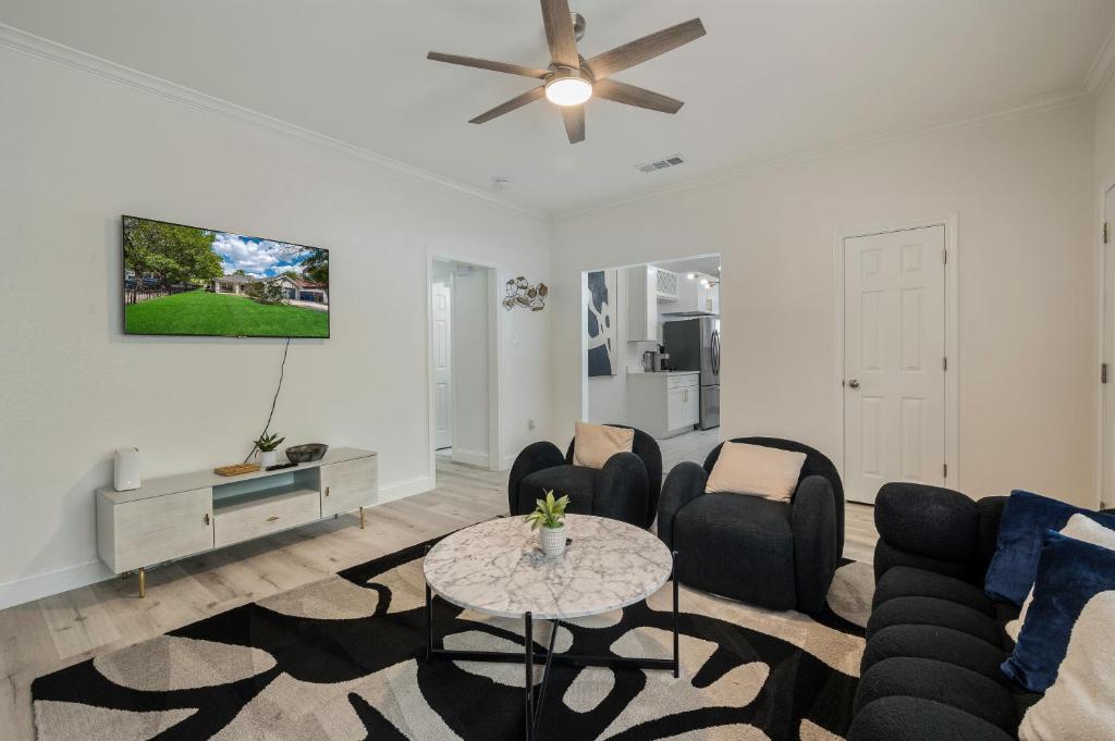 a living room with a couch and chairs and a table at Modern 3BR in Bishop Arts Walk to Shops in Dallas