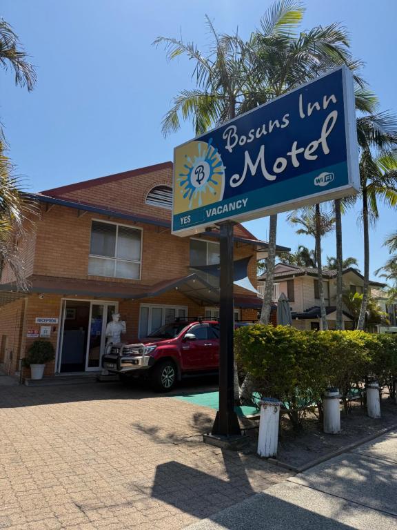 a sign for a motel in front of a building at Bosuns Inn Motel in Coffs Harbour