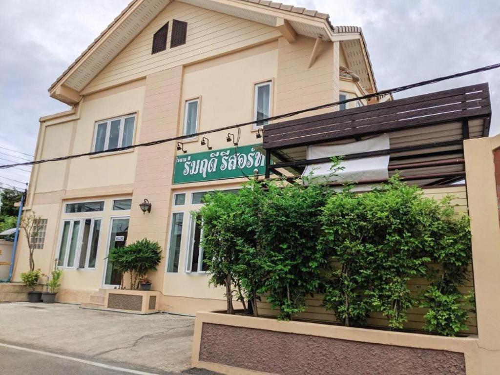 a building with a sign on the side of it at Romruedee Resort in Sattahip