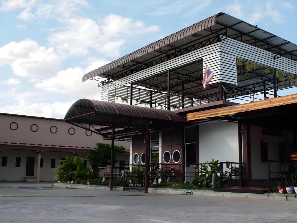 a building with an american flag in front of it at Surintara Resort in Surin