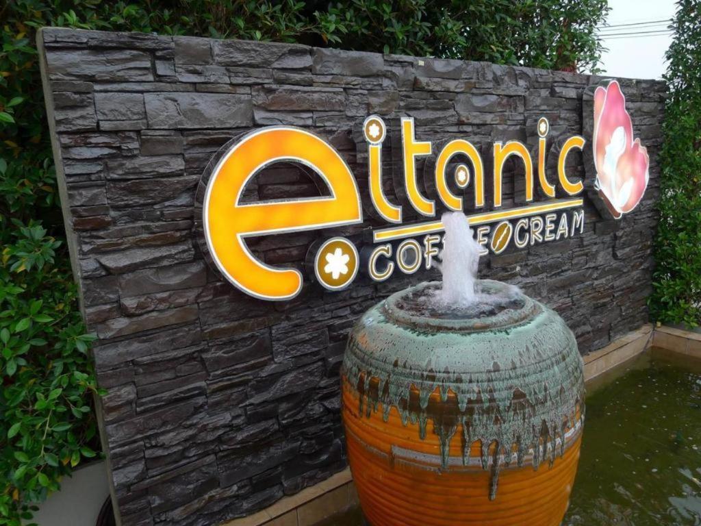 a sign with a fountain in front of a building at Eitanic Resort in Ban Don Tako