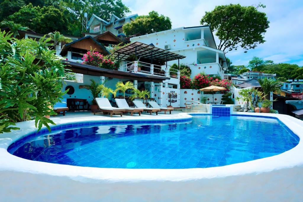 a swimming pool in front of a house at Steps Garden Resort in Sabang