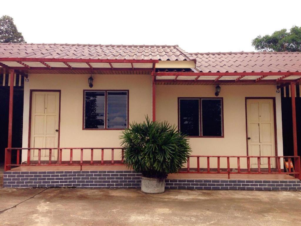 a house with a plant in front of it at Zigzag Resort in Ban Som Poi