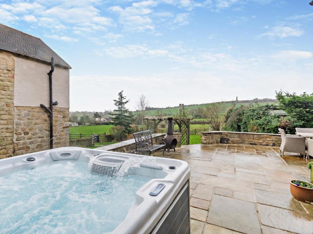 a hot tub on the patio of a house at 4 Bed in Crich 93830 in Crich