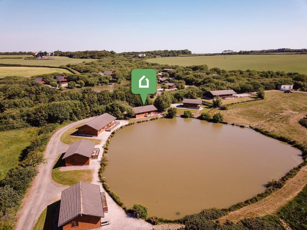 an aerial view of a farm with a large pond at 3 Bed in Clovelly 00359 in Clovelly