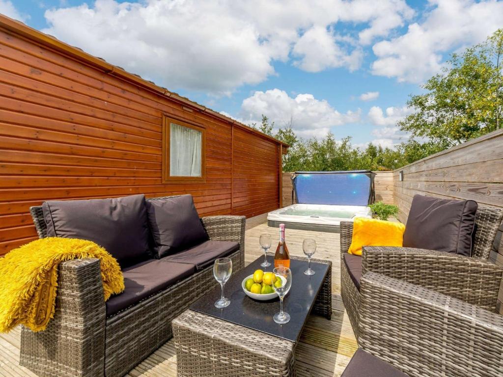 a patio with a couch and chairs and a table at 2 bed property in Morpeth 89070 in Felton