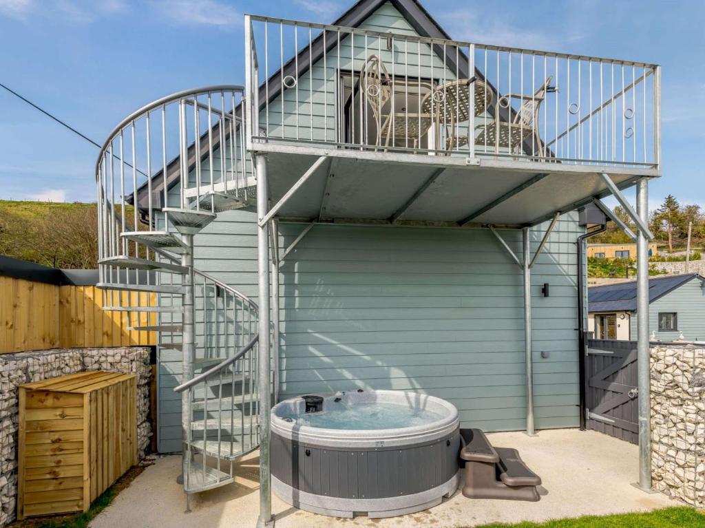 a deck on a building with a hot tub at 1 Bed in Weymouth 82098 in Osmington