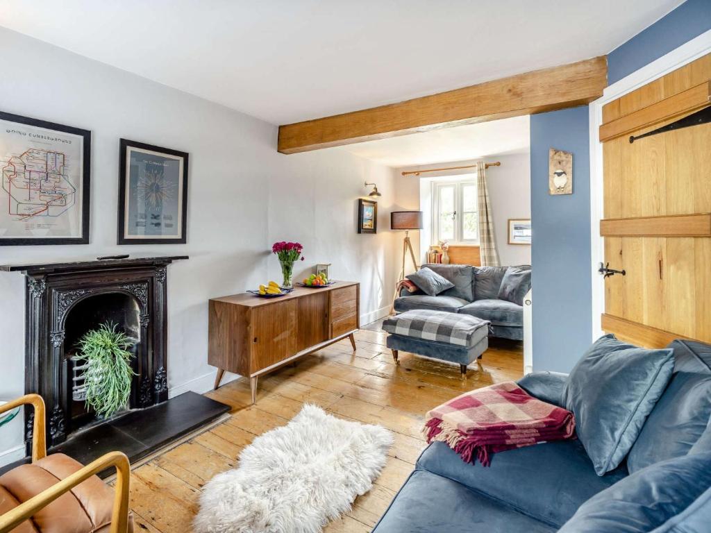 a living room with a couch and a fireplace at 3 Bed in Newby Bridge 87960 in Greenodd