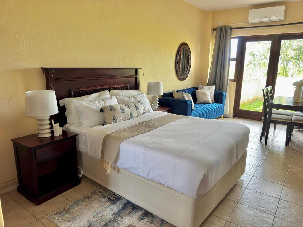 a bedroom with a large bed and a living room at Ocean View Villa Studio Apartment A01 in Port Edward