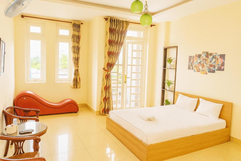 a bedroom with a bed and a table and a chair at 158A Hotel in Ho Chi Minh City