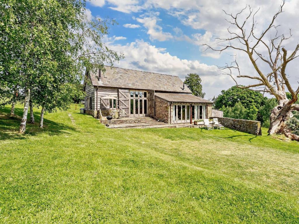 an exterior view of a stone house with a yard at 2 Bed in Abergavenny 66630 in Dorstone