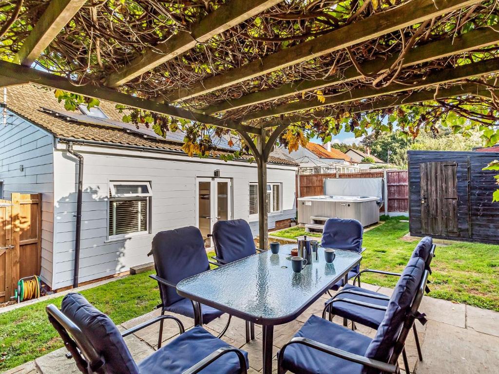 a patio with a table and chairs under a pergola at 2 Bed in Cromer 29556 in Cromer