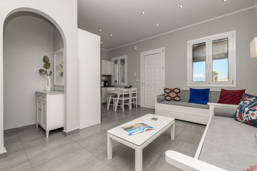 a living room with a couch and a table at Demargia Villa C - Loft Apartment in Zakynthos Town in Zakynthos Town
