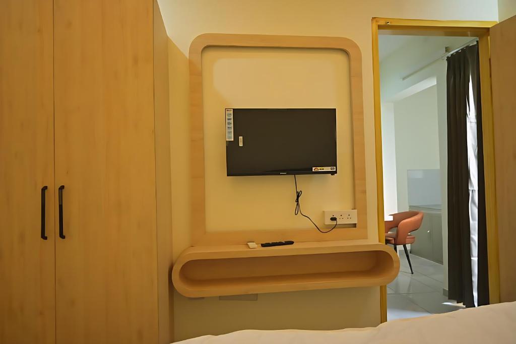 a bedroom with a tv on a wall at Shree shyam hotel & restaurant in Mahendragarh