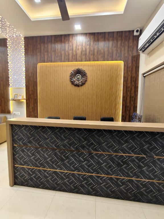 a reception desk in a office with a brown at Satguru Villa in Varanasi