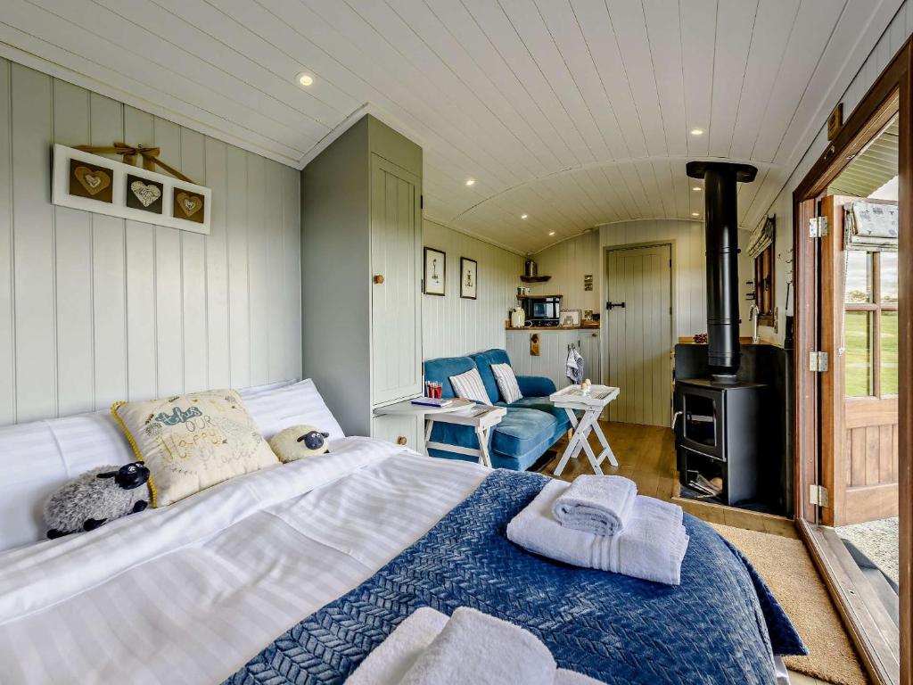 a bedroom with a large bed and a stove at 1 Bed in Holsworthy 77361 in Ashwater