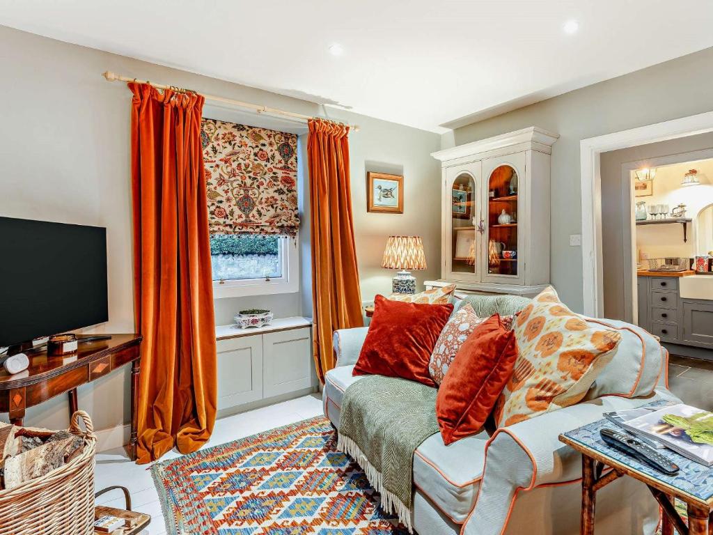 a living room with a couch and a television at 1 Bed in Gavinton 95832 in Duns