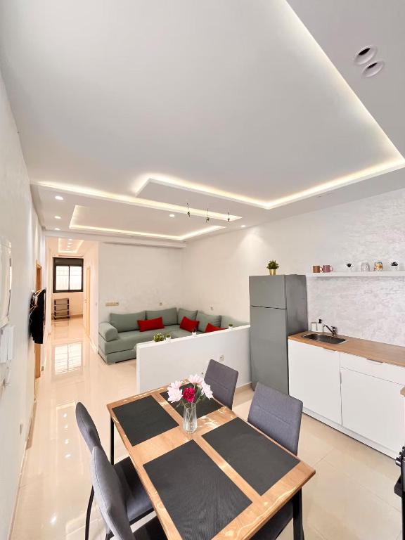 een keuken en woonkamer met een tafel en stoelen bij Large 2BR Apartment Near Agadir Medina in Agadir