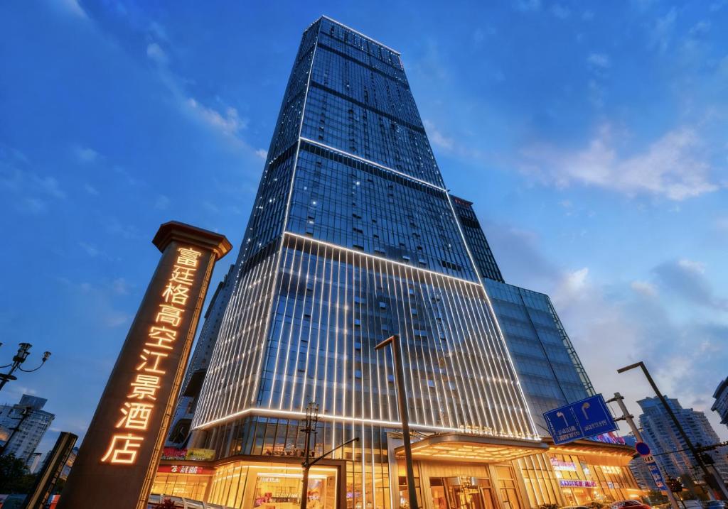 a tall building with a sign in front of it at Futinger High-altitude River View Hotel in Chongqing