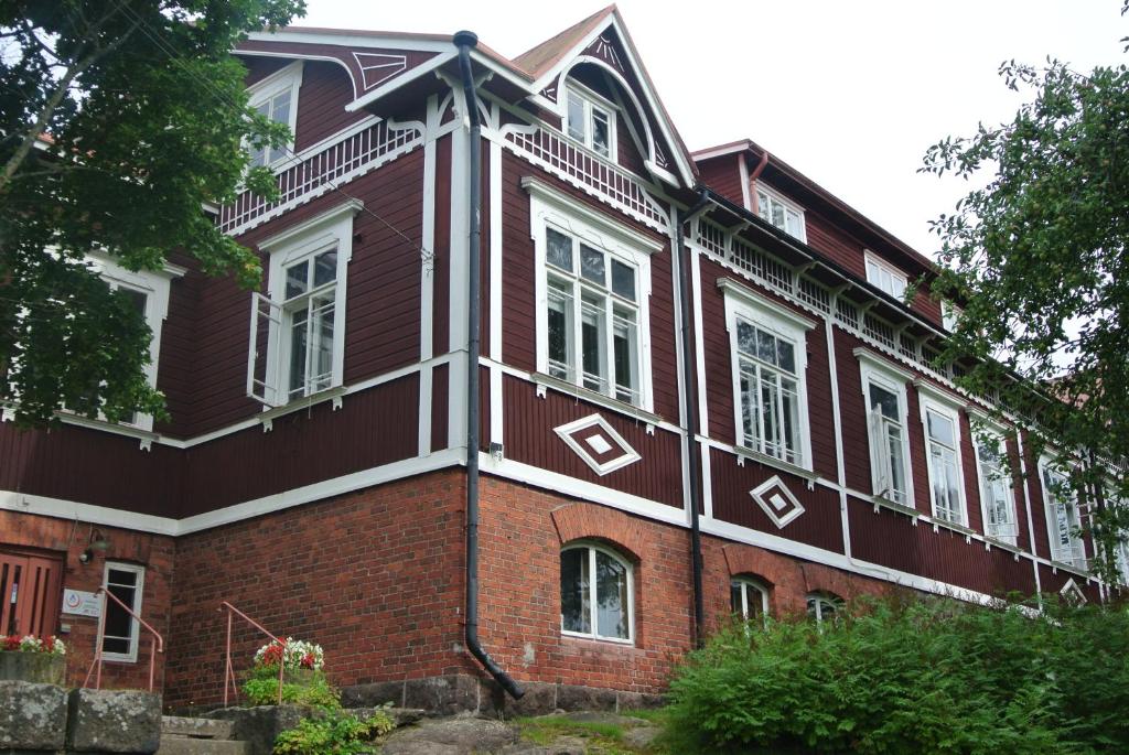 a large red brick building with white windows at Porvoo Hostel in Porvoo