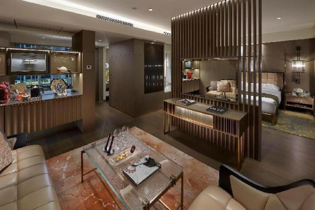 a living room with a couch and a bed at The Landmark Mandarin Oriental, Hong Kong in Hong Kong