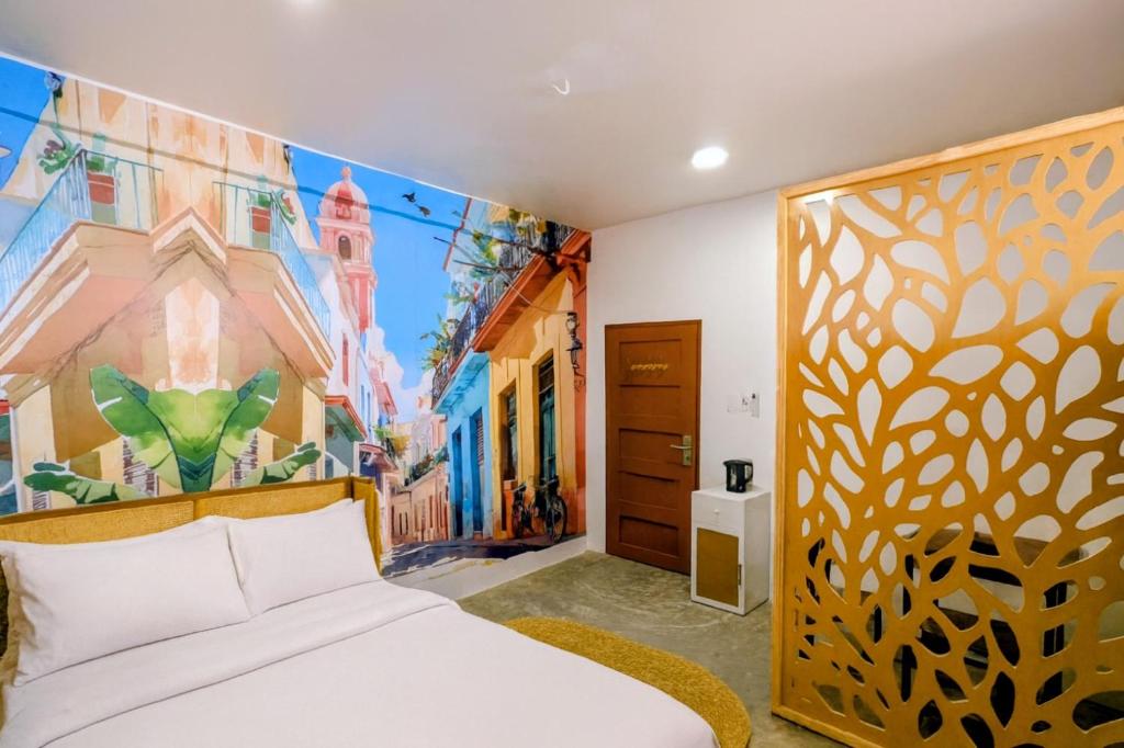 a bedroom with a bed and a painting on the wall at Bellimena Stone Town in Zanzibar City